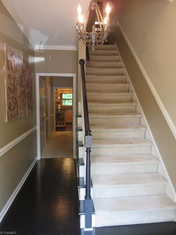 538 Lindley Road Greensboro, NC 27410 - Photo 2 of 29 Upon entering sellers have installed richly gleaming hardwood flooring in the the foyer, hall, kitchen and breakfast rooms. The half bath is done the hall and entrance to the the lower level is on the right. They also added chair rail in the foyer hall and stairway.