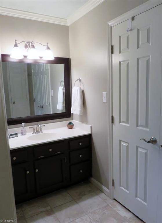 538 Lindley Road Greensboro, NC 27410 - Photo 18 of 29 New wide tile floors grace the bath area. Vanity area one is shown here outside a very long master closet.