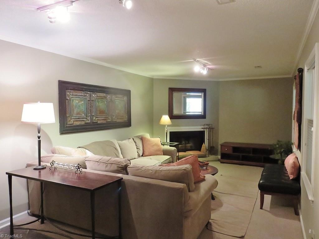 538 Lindley Road Greensboro, NC 27410 - Photo 23 of 29 The lower level den has a wood burning fireplace and entry to the patio.