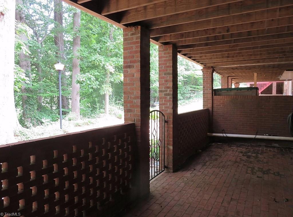 538 Lindley Road Greensboro, NC 27410 - Photo 28 of 29 Walk out from the den to a large brick patio area. There is no lack for outdoor living space in this unit!