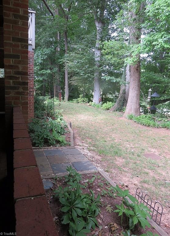 538 Lindley Road Greensboro, NC 27410 - Photo 29 of 29 The property is backed by tall hardwoods and garden areas with a nice walking space should you have pets.