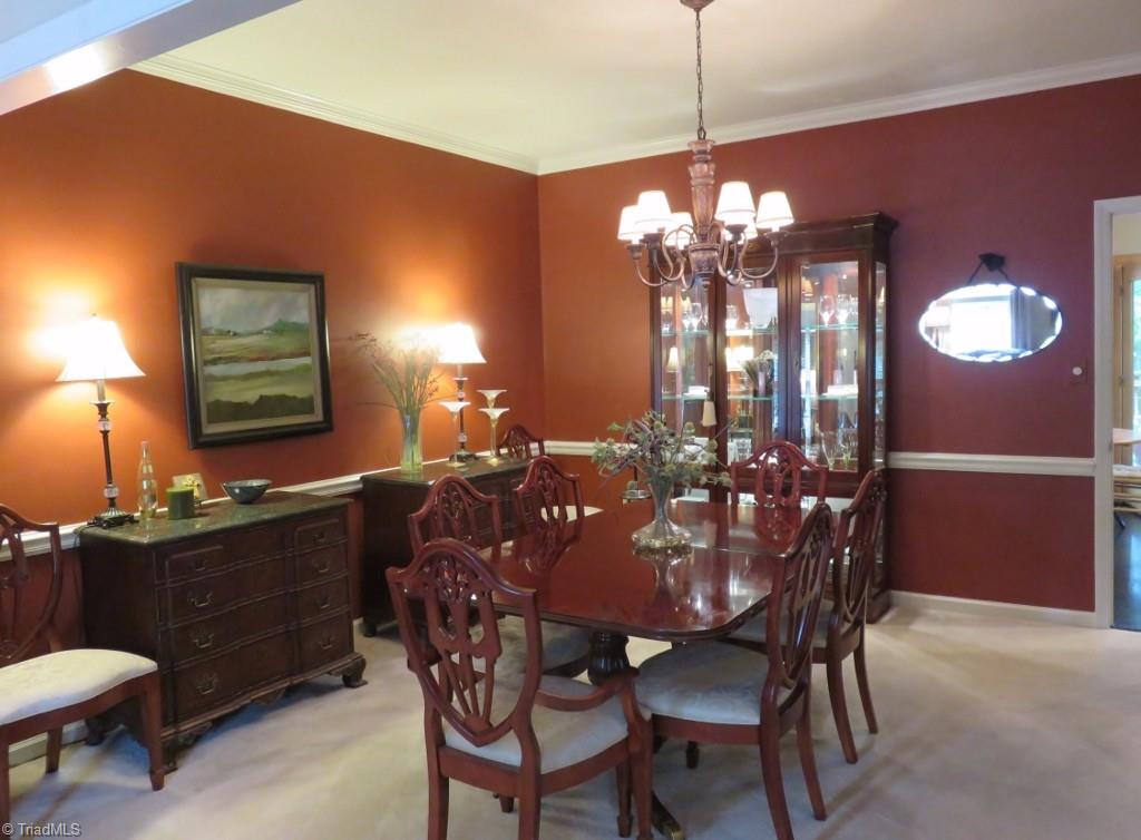 538 Lindley Road Greensboro, NC 27410 - Photo 5 of 29 This warm and inviting dining room features chair rail and new chandelier.