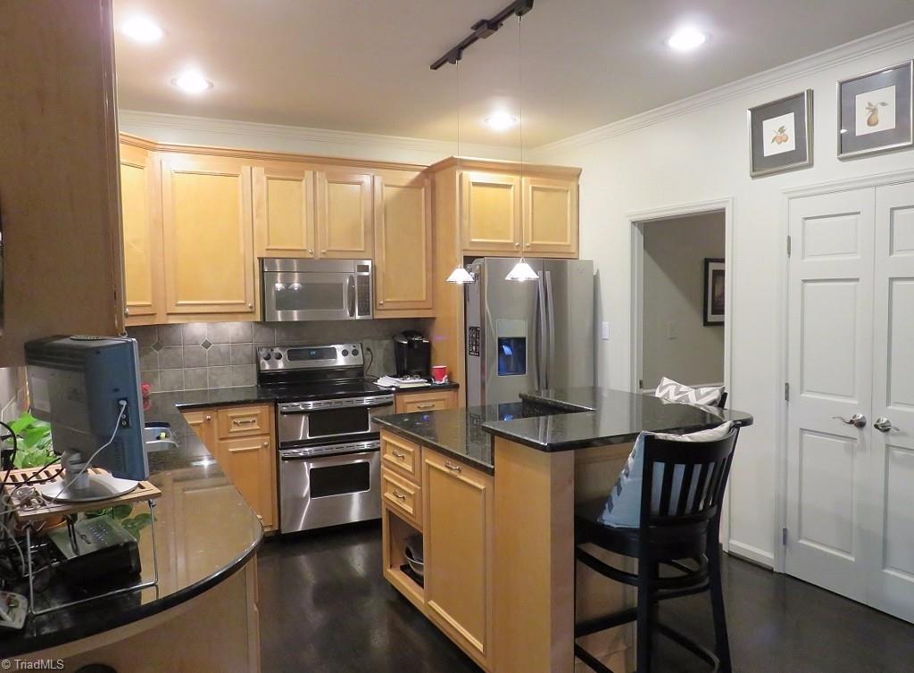 538 Lindley Road Greensboro, NC 27410 - Photo 9 of 29 This totally gutted kitchen has gleaming, richly stained hardwood floors, a pantry and a raised island for eating and food prep. All raised panel edged maple cabinets were custom designed.