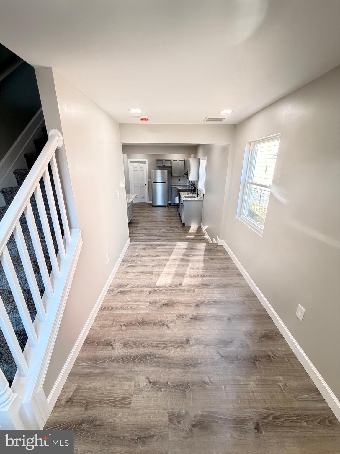 404 Sharp Street Millville, NJ 08332 - Photo 4 of 17 a view of a bedroom with wooden floor and staircase