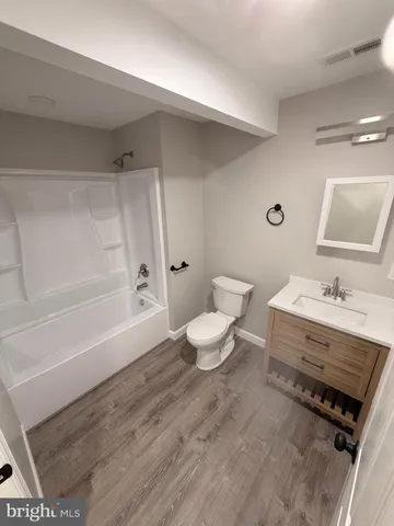 a bathroom with a sink a toilet and a bathtub