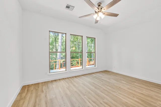 wooden floor in an empty room with a window