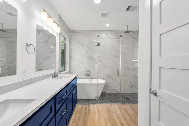 a bathroom with a double vanity sink mirror double and shower