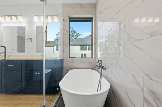 a bathroom with a bathtub and shower