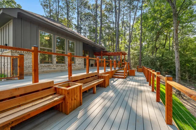 a view of balcony with chairs and wooden fence