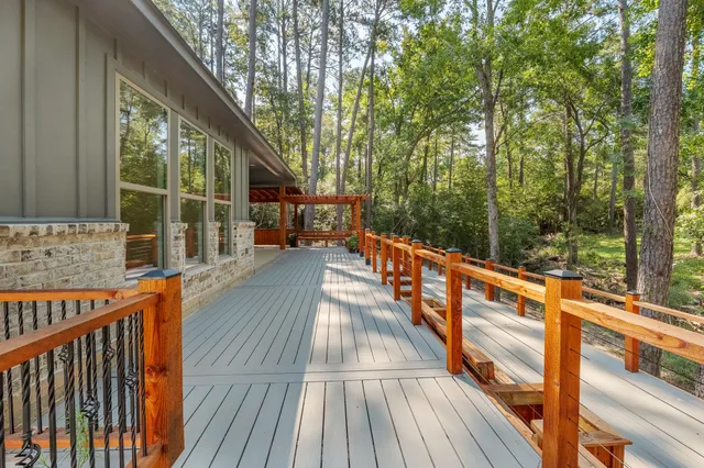 a view of balcony with wooden floor and fence
