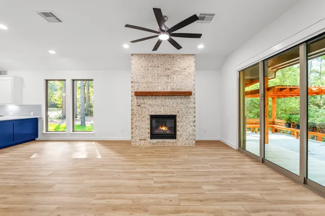 a view of an empty room with a fireplace and a window