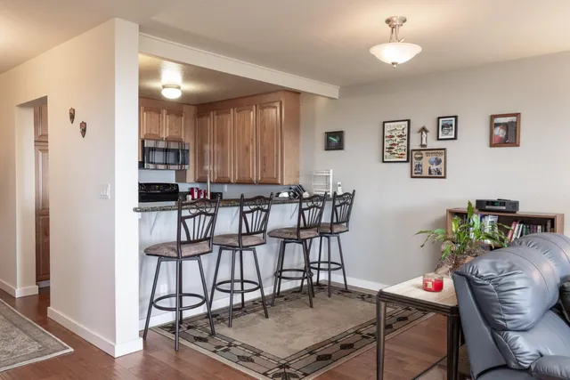 a kitchen with stainless steel appliances granite countertop a refrigerator and a stove