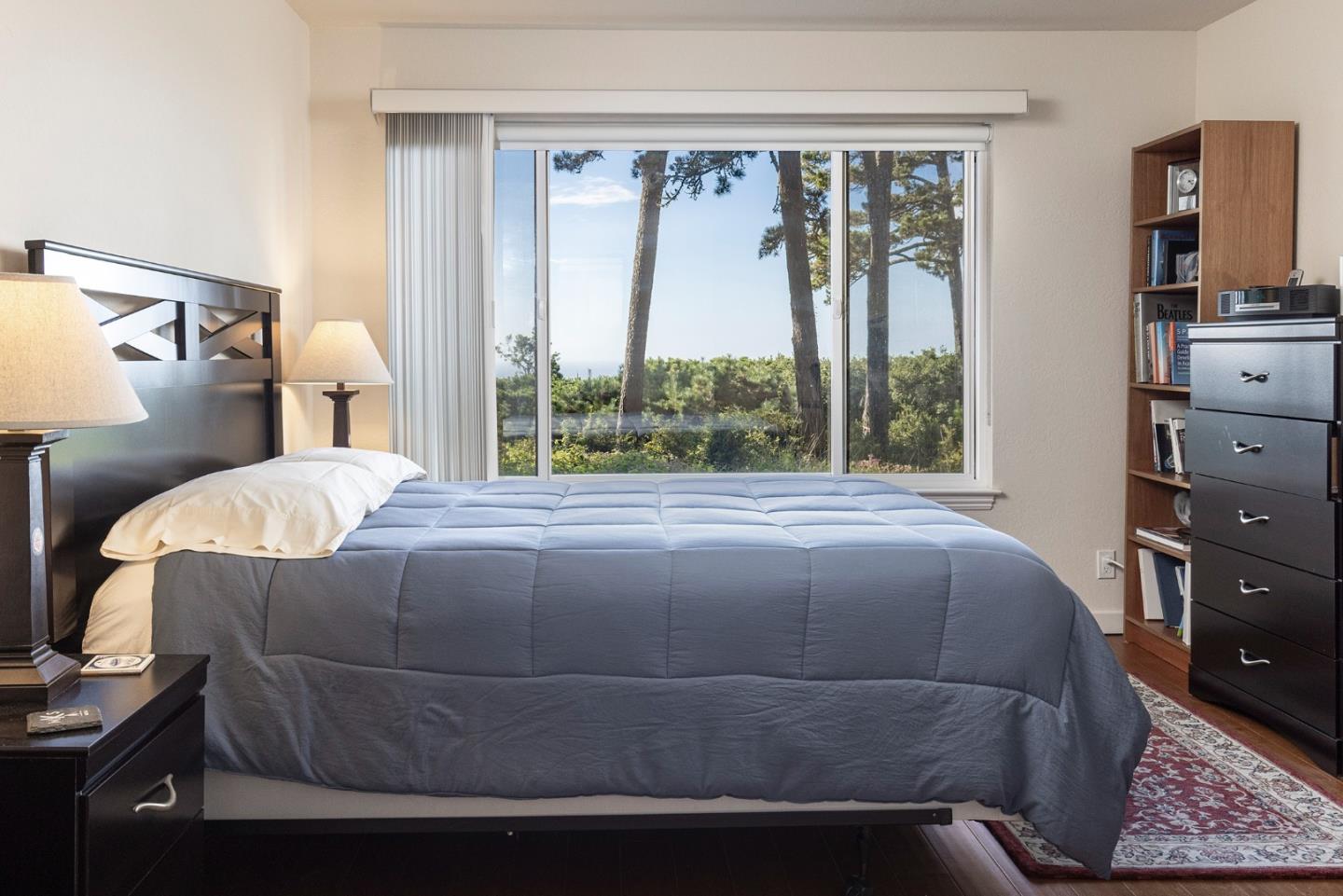 22 Ocean Pines Lane, Unit 22 Pebble Beach, CA 93953 - Photo 17 of 28 a bedroom with a bed and window
