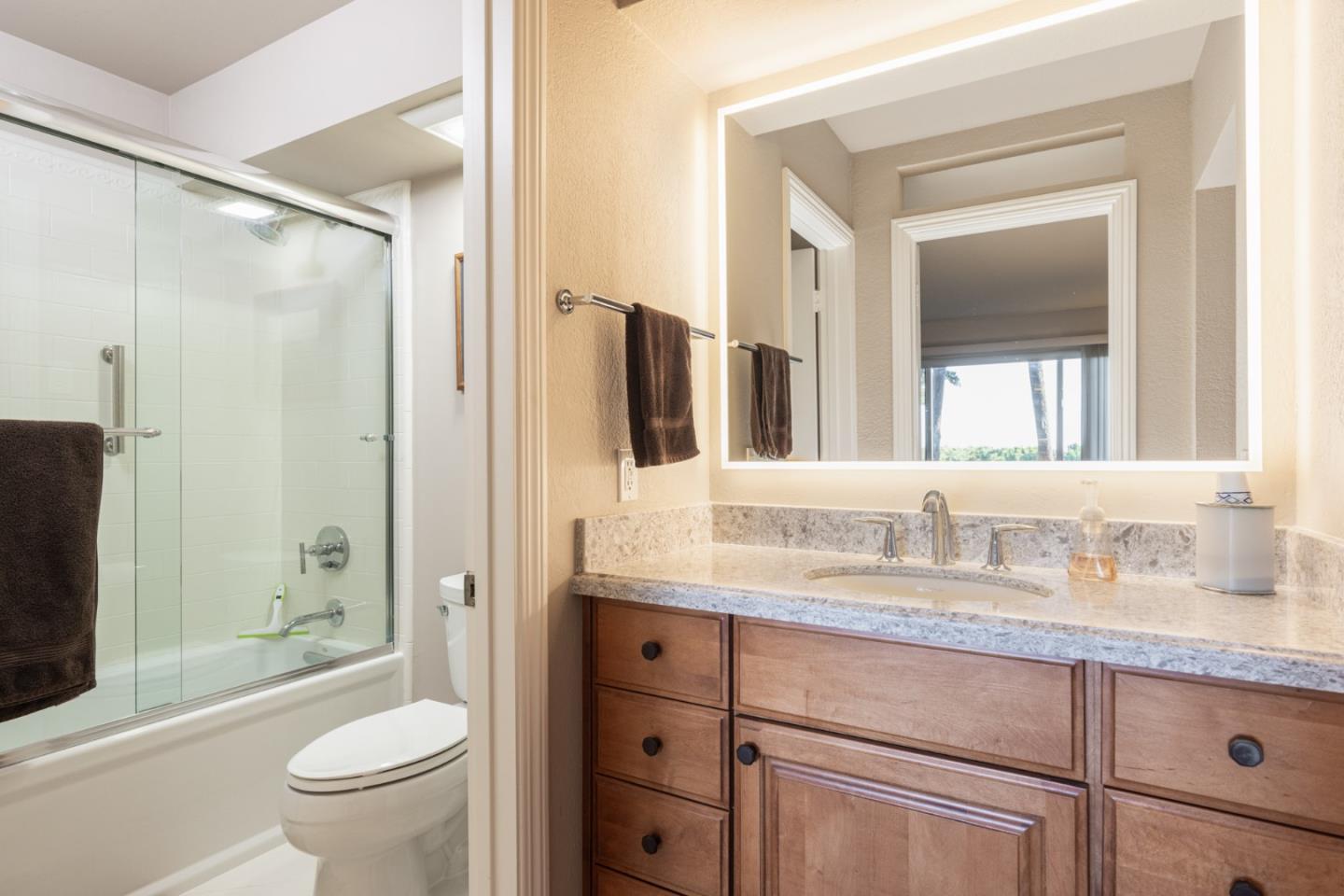 22 Ocean Pines Lane, Unit 22 Pebble Beach, CA 93953 - Photo 18 of 28 a bathroom with a granite countertop sink toilet and shower