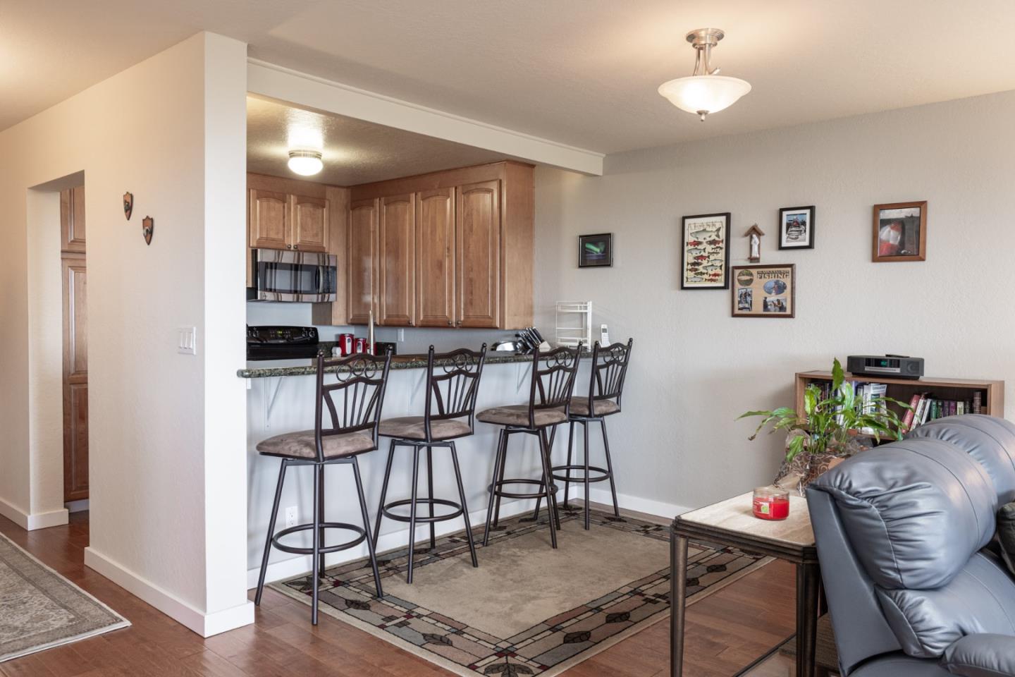 22 Ocean Pines Lane, Unit 22 Pebble Beach, CA 93953 - Photo 10 of 28 a reading room with furniture and wooden floor