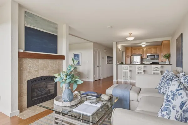 a kitchen with granite countertop a refrigerator and cabinets