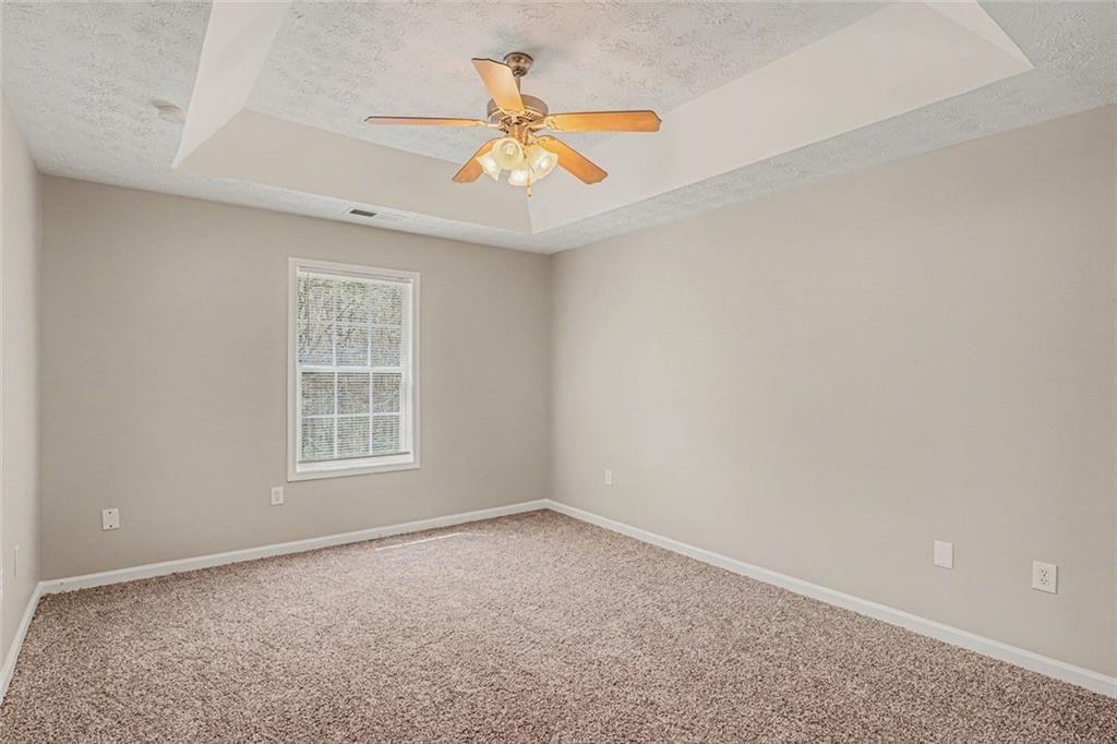 10 Wilbur Way Covington, GA 30016 - Photo 6 of 22 an empty room with window and ceiling fan