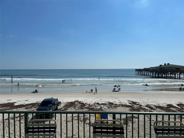 a balcony with chairs and wooden floor