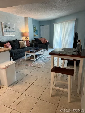 a living room with furniture a window and a table