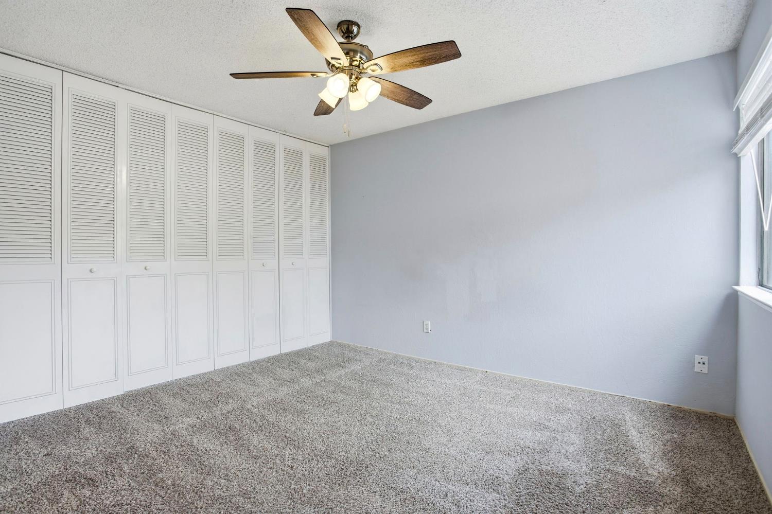 5805 Muldrow Road Sacramento, CA 95841 - Photo 22 of 27 Primary bedroom featuring a wall of closets