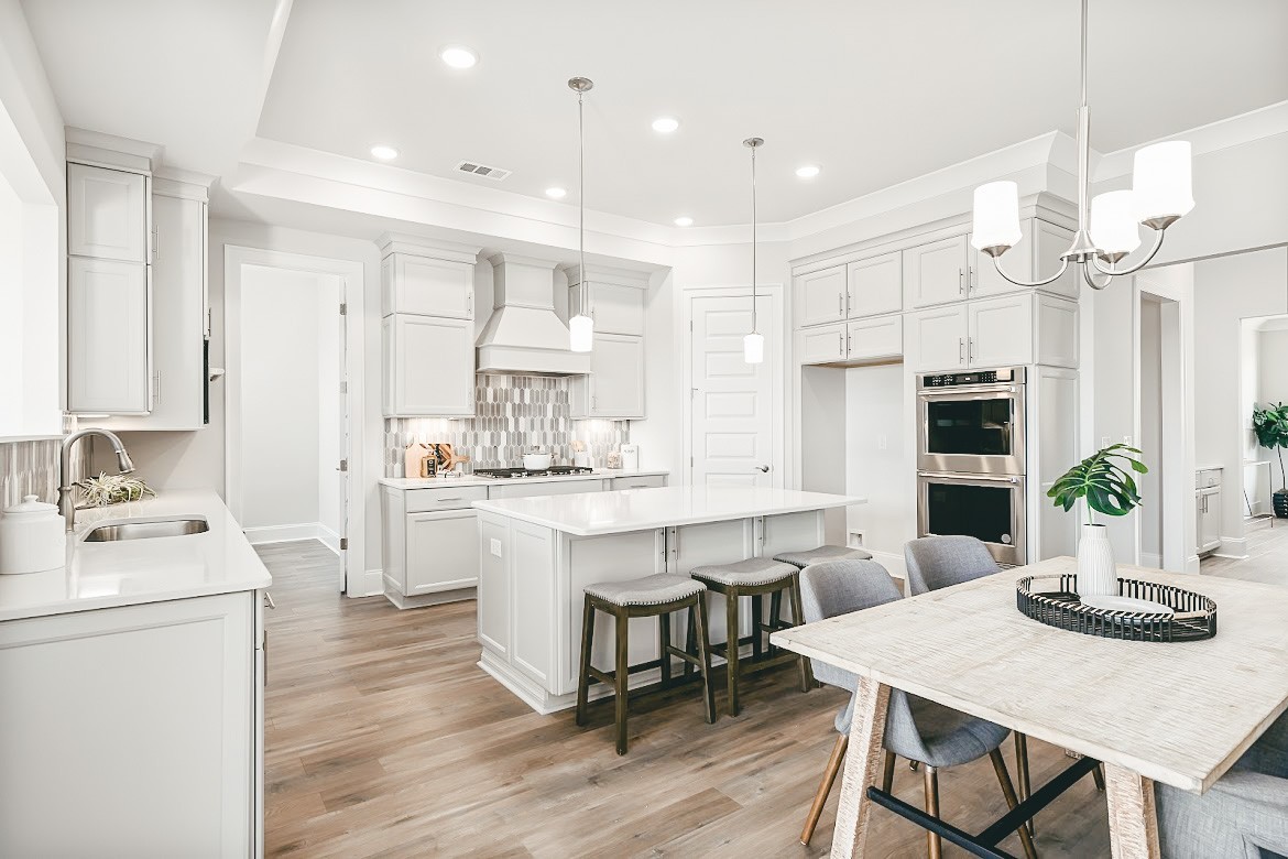 3238 Chase Point Drive Franklin, TN 37067 - Photo 5 of 29 a kitchen with kitchen island a dining table and chairs