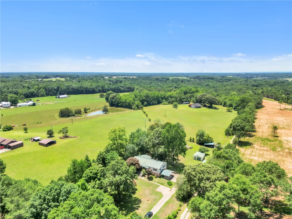 602 Harper Road Pendleton, SC 29670 - Photo 30 of 32 Vast green acreage unfolds with a private pond, offering a serene rural lifestyle.