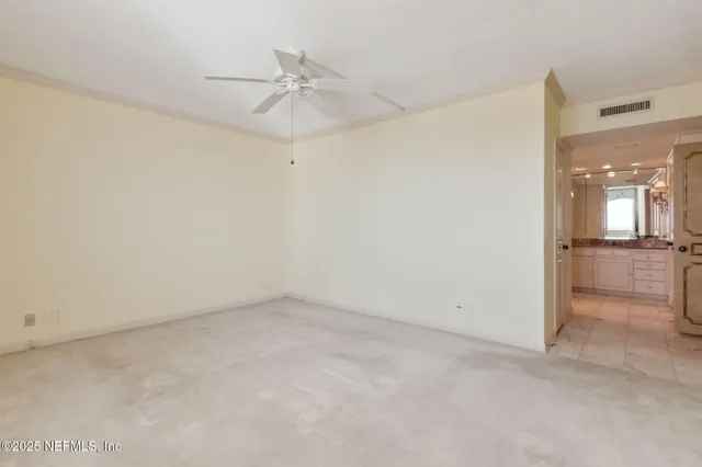 a view of a patio with a table and chairs and potted plants