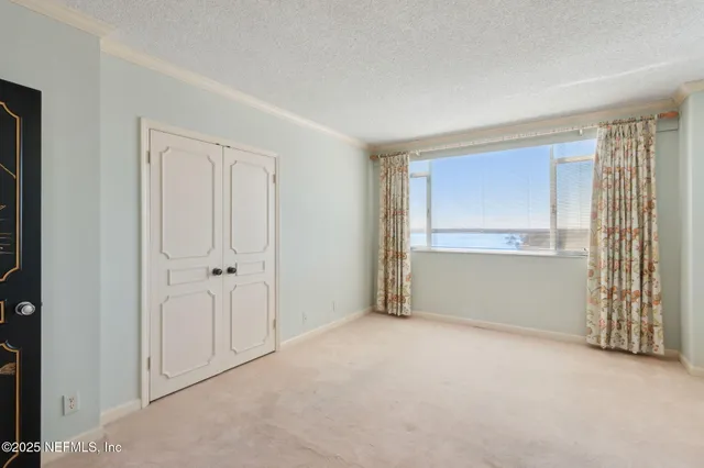 a view of a dining room with furniture and a kitchen