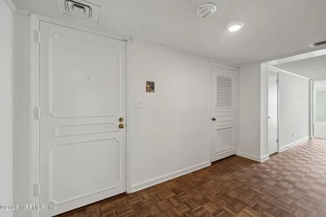 a kitchen with a sink white cabinets and stainless steel appliances