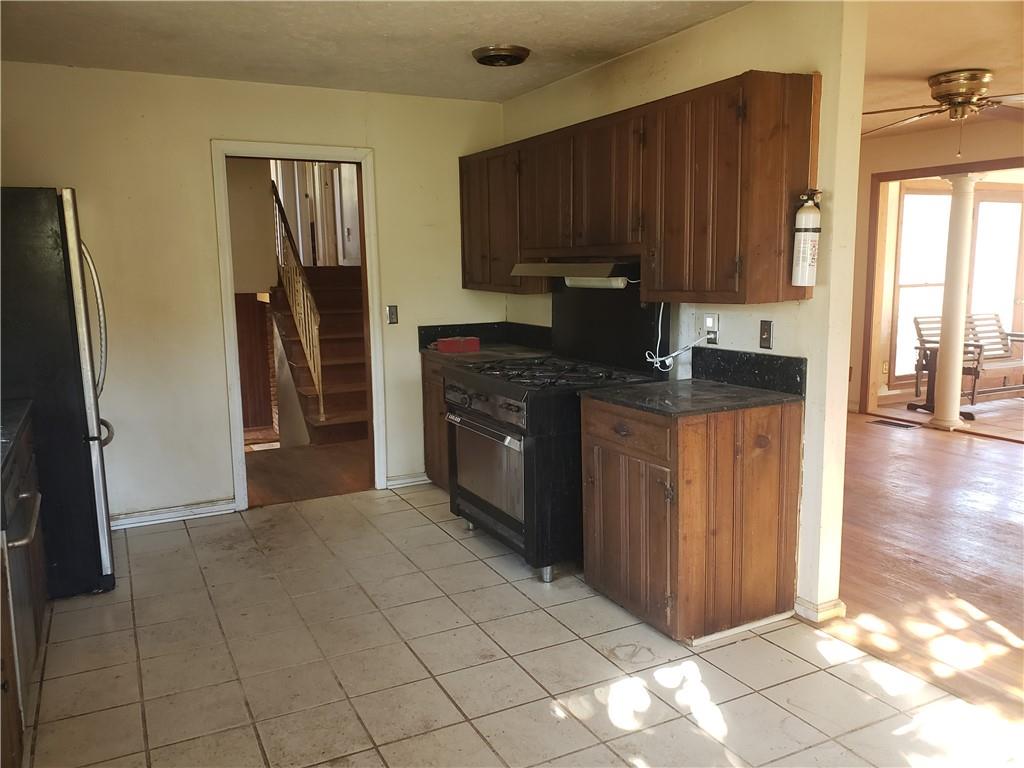 3553 Vanet Road Chamblee, GA 30341 - Photo 6 of 30 a kitchen with stainless steel appliances granite countertop a stove a refrigerator a sink and dishwasher with wooden cabinets