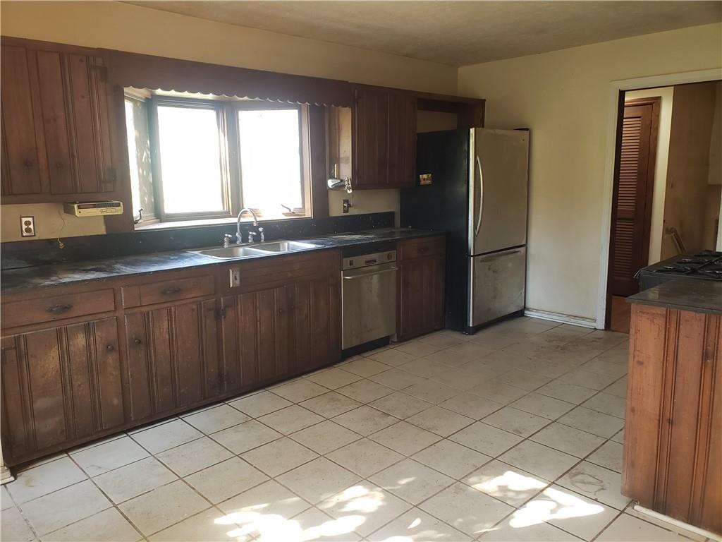 3553 Vanet Road Chamblee, GA 30341 - Photo 7 of 30 a kitchen with a sink a refrigerator and wooden cabinets