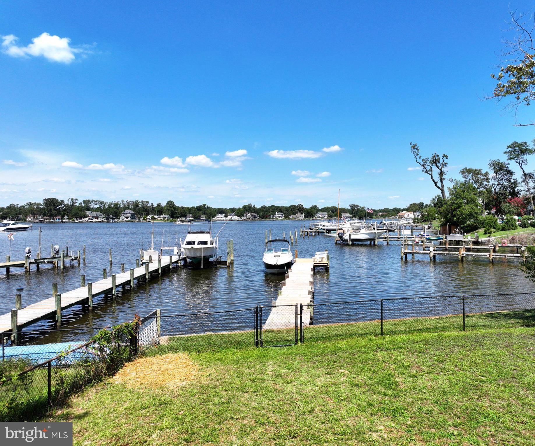 Serene waterfront with docked boats.