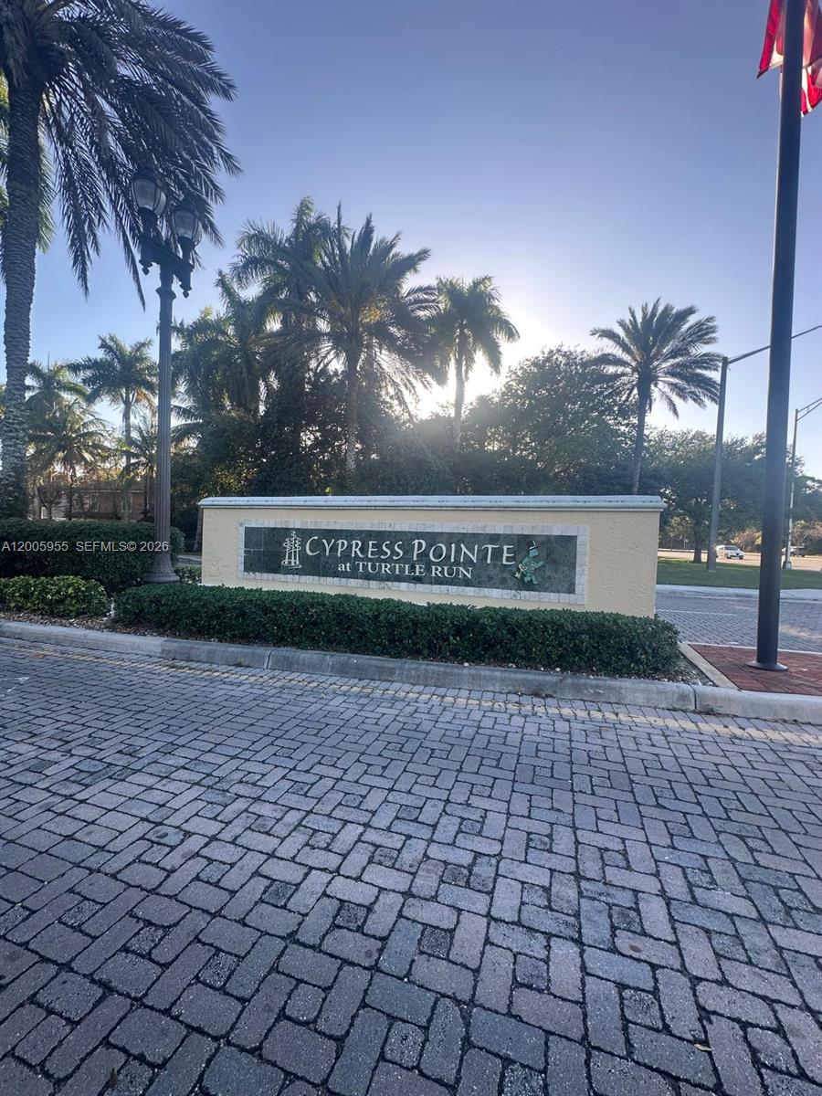 6920 West Sample Road, Unit 6920 Pompano Beach, FL 33063 - Photo 1 of 30 a front view of a building with a yard