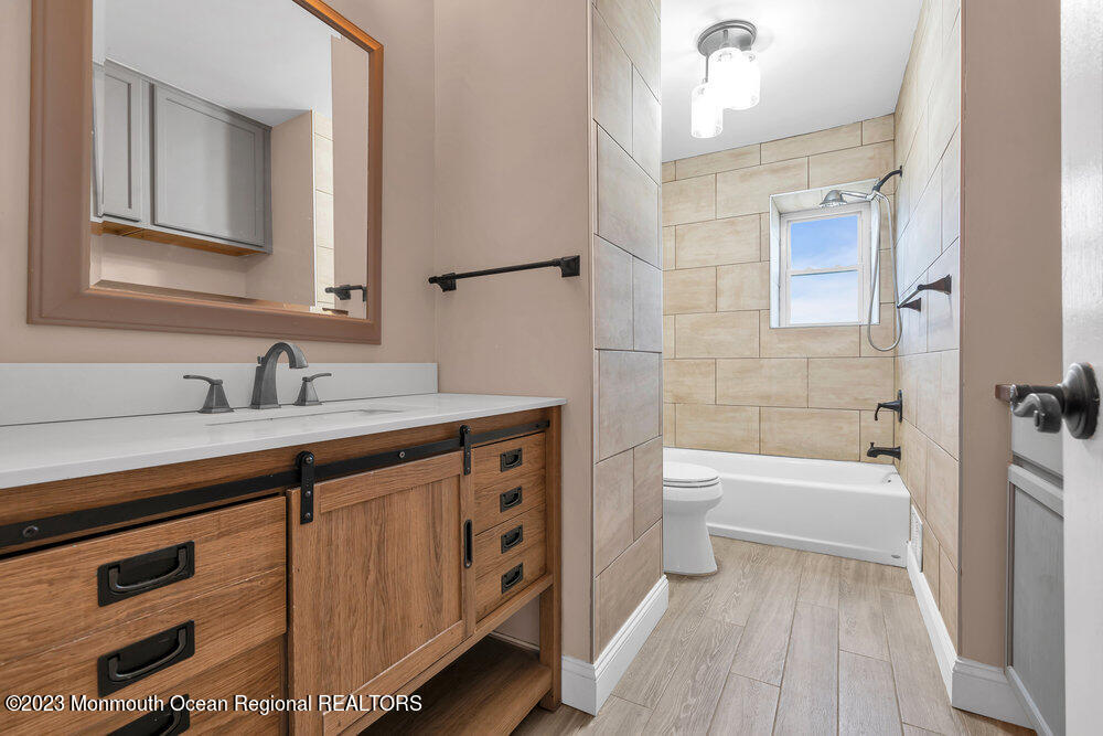570 Labanna Court Brick, NJ 08724 - Photo 12 of 28 a bathroom with a tub sink toilet and a mirror