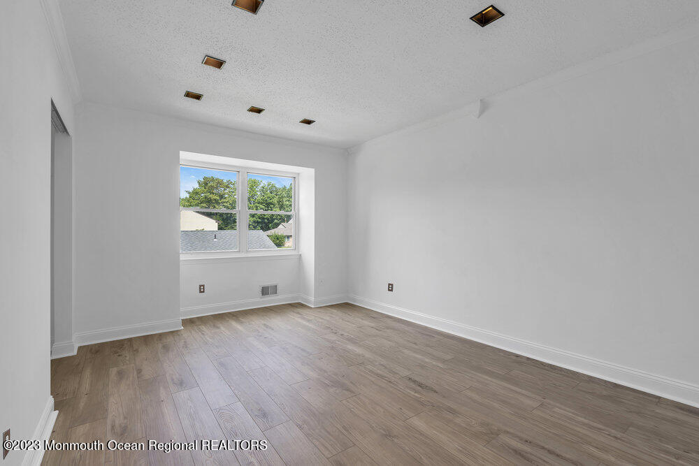 570 Labanna Court Brick, NJ 08724 - Photo 14 of 28 a view of an empty room with wooden floor and a window