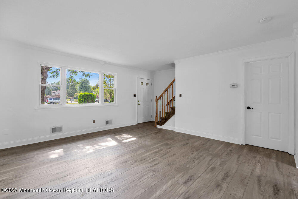 570 Labanna Court Brick, NJ 08724 - Photo 5 of 28 an empty room with wooden floor and windows