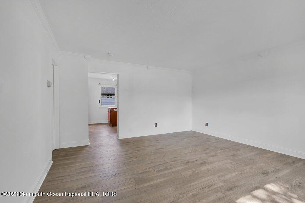 570 Labanna Court Brick, NJ 08724 - Photo 6 of 28 a view of an empty room with wooden floor and a window