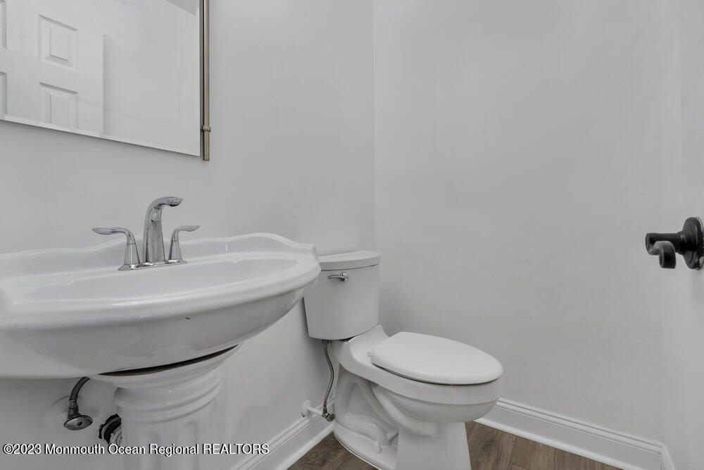 570 Labanna Court Brick, NJ 08724 - Photo 7 of 28 a bathroom with a toilet a sink and mirror