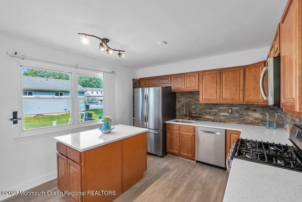 570 Labanna Court Brick, NJ 08724 - Photo 8 of 28 a kitchen with stainless steel appliances granite countertop a sink a stove and a refrigerator
