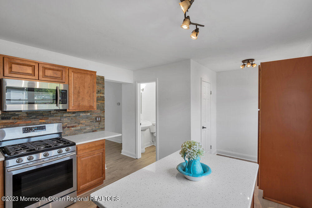570 Labanna Court Brick, NJ 08724 - Photo 9 of 28 a kitchen with stainless steel appliances a stove top oven a sink and a refrigerator