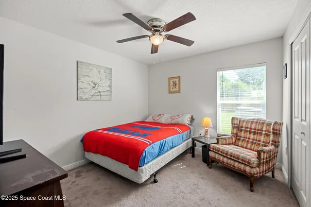 a bathroom with a granite countertop sink a large mirror and shower