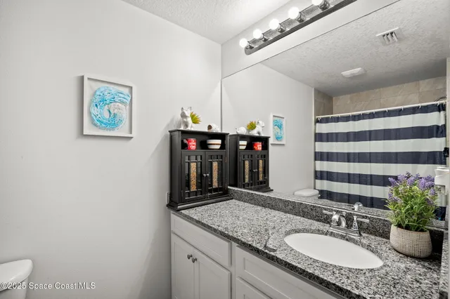 a living room with patio furniture and garden view