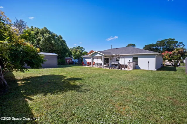 a view of a house with swimming pool and a yard