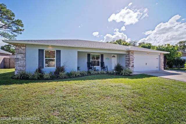 a garden with a bench in front of it