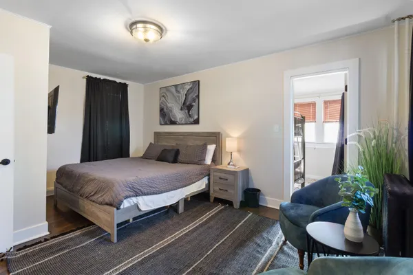 a bedroom with a bed and flat screen tv