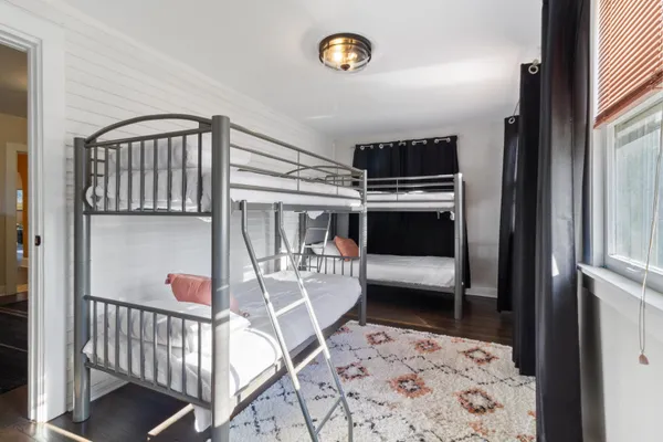 a bedroom with furniture and a window