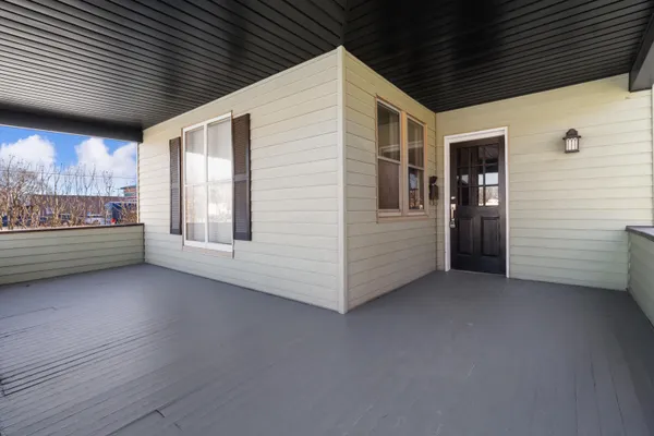 a view of a small space with wooden floor and a window