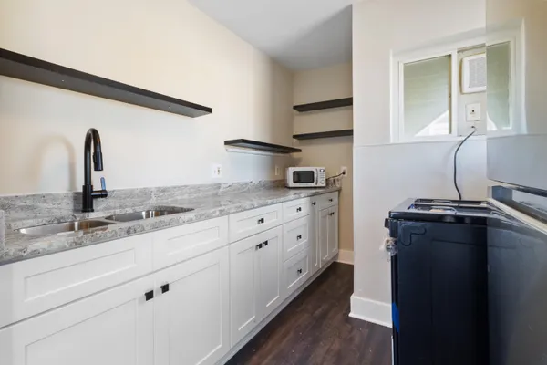 a kitchen with a refrigerator and a sink