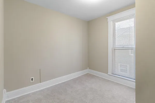 a bathroom with a granite countertop toilet a sink and a mirror