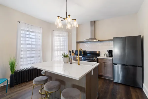 a large kitchen with dining table and chairs
